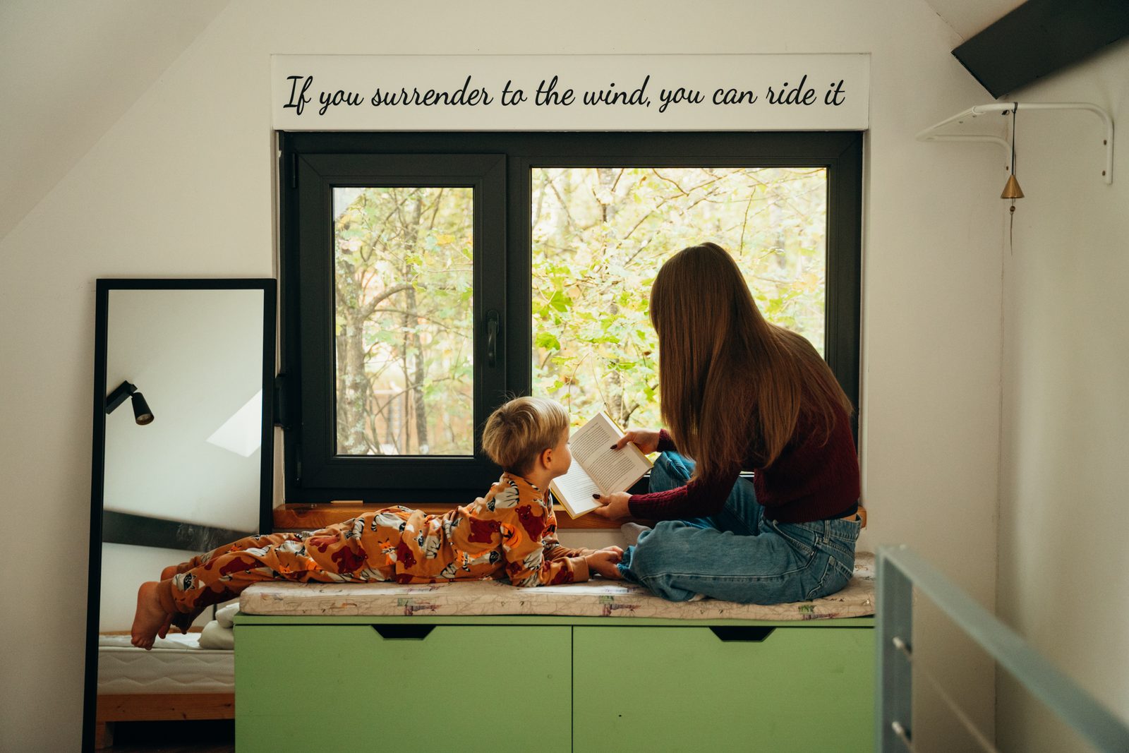 Reading aloud under the sloping roof.